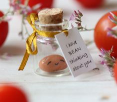 a message in a glass jar with tomatoes around it