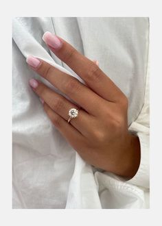 a woman's hand wearing a diamond ring