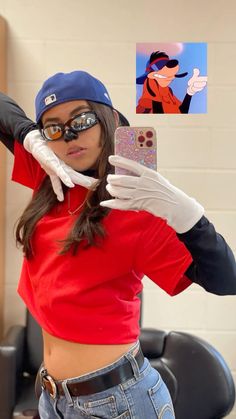 a woman in a red shirt and white gloves taking a selfie