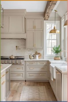 an image of a kitchen setting with white cabinets and gold accents on the countertops