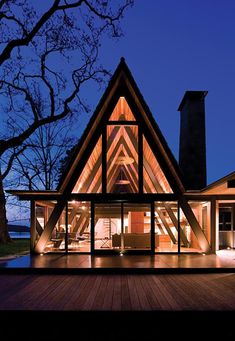 a large wooden house lit up at night