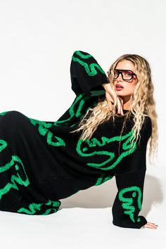 Lala Original Designs are thoughtfully designed in-house. These clothes were made for you.- Super oversized, shapeless silhouette- Green dinosaur pattern on a black background- Fuzzy 3D stitched dinosaurs- Material is thick, stretchy, and so soft-- no itch whatsoever- Slouchy, drapey fit- Long bell sleeves with drop shoulder- Midi length Sierra is 5'8", typically wears a size 8 and is wearing a S/M. Meg is 5'9", typically wears a size 2/4 and is wearing a S/M.100% acrylic© Dressed in LALA™ 2024 Oversized Knit Dress, Satin Playsuit, Green Dinosaur, Dinosaur Pattern, Blazer Set, Flannel Jacket, Oversize Knit, Sweater Collection, Winter Days