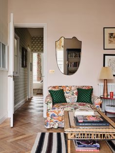 a living room filled with furniture and a mirror