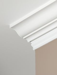 the corner of a wall with white paint and molding on it's edges