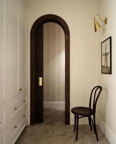 a chair sitting next to a doorway in a room