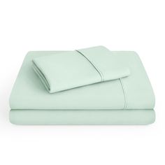 two sheets and one pillowcase are shown in light mint green color, with the covers folded down