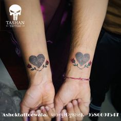 two people holding hands with tattoos on their wrist