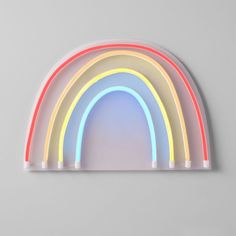 a rainbow shaped neon sign on the wall