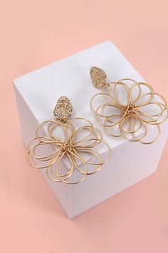 A fusion of floral beauty and modern design that will elevate your style and add a touch of sophistication to any outfit. These exquisite earrings feature intricately crafted matte flowers that are delicately entwined, creating a unique and elegant accessory.Product Details:length: 2.5" width: 1.75" earring back: Postmetal finish: gold, rhodium Platingproduct: Lead & Nickel Compliantanti-tarnish: Double E-coating Modern Gold Earrings For Spring, Filigree Flower Earrings, Elegant Metal Flower Charm Earrings, Elegant Metal Flower Earrings, Flower Dangle Earrings, Post Metal, Sunglass Chain, Wall Accessories, Huggie Hoop Earrings