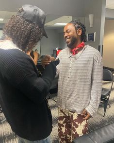 two people standing in an office talking to each other