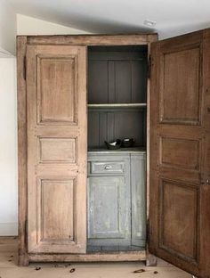 an open wooden cabinet with two doors