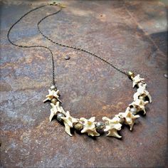 "-This unisex necklace is an interesting combination of graduated weasel vertebrae and handmade Ethiopian silver and brass beads. -The necklace is 27\" in total length, and can easily be layered with other longer or shorter necklaces. -Beads and vertebrae are strung onto an antique-brass chain, and finished with a matching lobster clasp. -No animals were harvested to make this necklace. -Designed and handmade in South Pasadena, CA. Check out more of our necklaces here: https://www.etsy.com/shop/ Taxidermy Jewelry, Witchy Necklace, Pagan Necklace, Bone Crafts, Real Bones, South Pasadena, Bone Art, Bone Necklace, Bone Jewelry