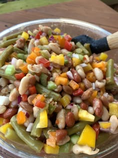 a glass bowl filled with beans and veggies