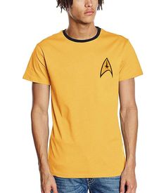 a man with dreadlocks wearing a yellow star trek t - shirt and blue jeans