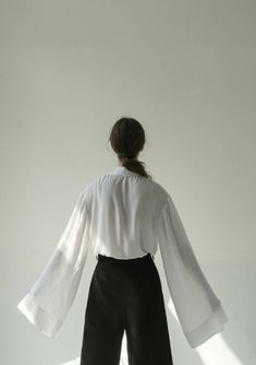 Get lost in the white viscose shirt, found in a limbo between blouse and light outwear. Presented in a soft fluid viscose, the wide barrel cuffs are designed to be worn long. Combines a strong architectural pointed collar and pleated front panel with a soft membrain and hidden buttons.Composition 100% viscoseWash carefully by handHandmade in Ukraine by women artisans for womenK M by L A N G E is a creative design studio based between Barcelona and KyivAll items are crafted out of quality materia Creative Design Studio, Shirt Cuff, Sewing Design, Wide Cuff, Women Artisans, Kiev, The White, Creative Design, Ukraine