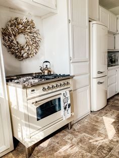 a white stove top oven sitting inside of a kitchen