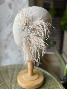 Beige feather ear cuff, Festival and wedding hair feather, Natural ostrich feathers, Burning man cosplay, Boho Ear wrap cuff no piercing This ostrich feather ear cuff beige color will definitely make your outfit so wild! Slip on an ear cuff for a look that will transform your ear immediately!  This is a perfect bridal Boho cuff earring created with  crystal, pearls beads and feathers. Our jewelry design is inspired by nature and made with the highest attention to detail and quality Be beautiful and unique with Vetochka4U jewelry! Decor - all length 13 cm = 5 inch Length ear cuff 6 cm = 2,3 inch Chain 8 cm = 3,14 inch The base of the cuff is flexible and you can give any shape! It's very comfortable and easy to wear. Price is for a single piece + earring (crystal or feather) Ready to ship i Adjustable Feather Trim Fascinator For Wedding, Wedding Fascinator With Feather Trim, Wedding Fascinator With Adjustable Feather Trim, Wedding Fascinator With Feather Trim And Adjustable Fit, Bohemian Adjustable Fascinator For Weddings, Wedding Feather Headband Hair Accessories, Adjustable Feathered Wedding Costume Hats And Headpieces, Wedding Costume Hats With Feather Trim, Adjustable Feather Trim Wedding Headpieces