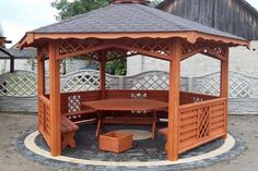 a wooden gazebo with benches around it