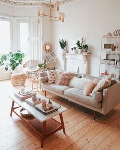 a living room filled with furniture and a fire place next to a large open window