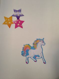 the wall is decorated with stars and unicorns