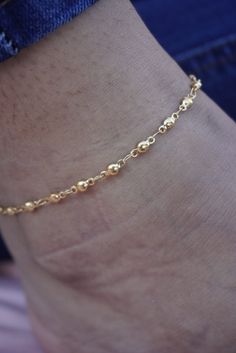 A beautiful and durable anklet that is perfect for everyday wear. The gold plating is of excellent quality and will not tarnish over time. The anklet is also hypoallergenic and gentle on the skin, making it a comfortable choice for those with sensitive skin. Dainty Hypoallergenic Everyday Anklets, Dainty Hypoallergenic Anklets For Everyday Use, Adjustable Gold Anklets With Satellite Chain, Dainty Adjustable Tarnish-resistant Anklets, Casual Gold Minimalist Anklets, Everyday Minimalist Gold Anklets, Minimalist Gold Anklets For Everyday, Gold Anklet With Chain Design For Gift, Skin-friendly Gold Minimalist Anklet