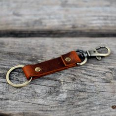 a leather keychain with a metal ring on it