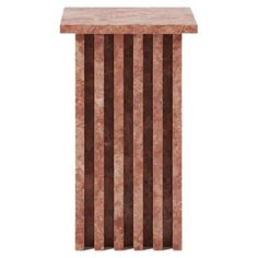 a brown and white marble pedestal with vertical stripes on the top, in front of a white background