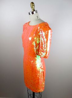 "An absolutely breathtaking color! This beauty is fully embellished with iridescent orange sequins and in perfect condition! Measurements: Bust - 32/34\" Waist - 27\" Hips - 36\" Dress Length - 32\" This amazing dress comes from a pet-free and smoke-free home. If you would like more info or have any questions, please ask!" Elegant Orange Sequin Dress, Orange Evening Dress For Party Season, Embellished Orange Evening Dresses, Glamorous Orange Evening Dress, Orange Sequined Dress For Party, Glamorous Orange Wedding Dress, Orange Cocktail Dress For Party Season, Glamorous Orange Dress, Festive Embellished Orange Dresses