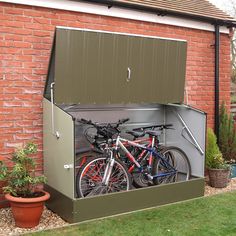 two bikes are parked in the back of a storage shed