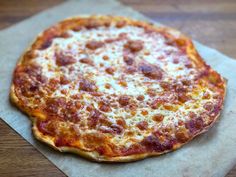 a pizza sitting on top of a piece of wax paper