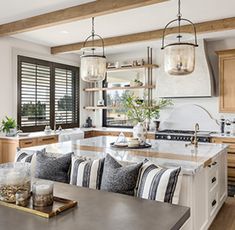 a kitchen filled with lots of counter space next to a dining room table and chairs