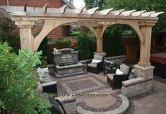 an outdoor living area with seating, fire pit and pergolated patio furniture in the foreground