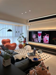 a living room filled with furniture and a flat screen tv mounted to the side of a wall