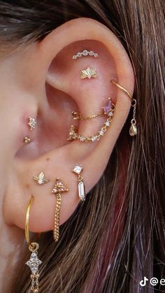 an ear with several different types of piercings on it