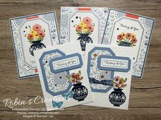 three cards with vases and flowers on them