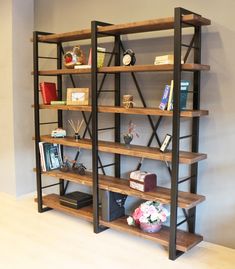 the bookshelf is made out of wood and metal, with several shelves on each side