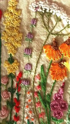 an embroidered piece with flowers on it