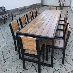 an outdoor table and chairs made out of wooden planks with black metal frame legs