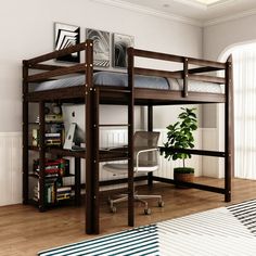 a loft bed with desk underneath it in a room that has hardwood floors and white walls