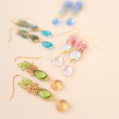 Dripping in gems, these long gemstone drop earrings are a handmade combination of beautiful bezel set stones and clusters of gems.- 2.5" long- French hooks- 14k gold plated .925 fine Italian sterling silver- Made in the USA in our NYC studio- Packaged in a gift box- Free shipping in the US Made to last, our unique gold plating technique makes these earrings tarnish resistant. The nature of natural gemstones makes each pair one-of-a-kind. Gemstone Earrings Gold, Gemstone Drop Earrings, Peridot Earrings, Tourmaline Earrings, Long Drop Earrings, Peridot Gemstone, Blue Quartz, Gemstone Necklace Pendant, Cluster Earrings