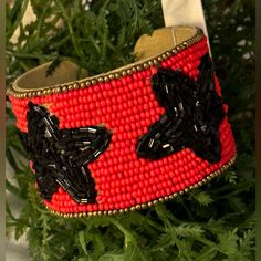 Red/Black Star Seed Bead Game Day Cuff Bracelet Red Beaded Bracelets With Black Beads For Festival, Adjustable Black Cuff Bracelet With Colorful Beads, Festive Black Bangle Bracelets, Festive Black Bangle Bracelet, Black Bangle Bracelets For Festive Occasions, Red Beaded Cuff Bracelet Bangle, Red Star-shaped Beaded Jewelry, Red Beaded Cuff Bracelet, Star-shaped Beaded Party Bracelets