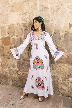 Discover the epitome of bohemian elegance with our Cotton Embroidered Maxi Dress, a masterpiece meticulously crafted by skilled artisans in Mexico. This exquisite dress features intricate hand-embroidery, showcasing the rich cultural heritage of Mexican craftsmanship.  With its flowing silhouette and soft, breathable cotton fabric, it's the perfect blend of comfort and style for any occasion, transporting you to a world of timeless beauty. It has ties in the back for an adjustable fit.  This dre Latina Fashion Dresses, Dress Latina, Mexican Style Dresses, Mexican Embroidered Dress, Boho Gown, Mexican Outfit, Chique Outfits, Latina Fashion, Mexican Dresses