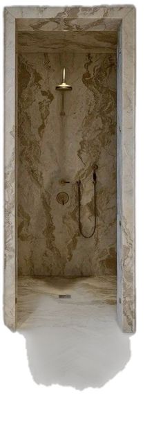 a bathroom with marble walls and a shower head