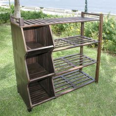 a wooden shelf sitting on top of a lush green field