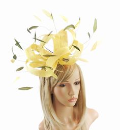 Hats By Cressida Kentucky Derby & Ascot Fascinator Hats Lemon Yellow Olive Green Fireball Feather & Sinamay Fascinator  Beautiful lemon yellow sinamay loops with yellow and olive green coque feathers Body measures about 10-12 inches wide, wider with feathers Mounted with a matching headband. If you prefer a headband to match your hair, please make a note at check out what colour headband you want. Add a touch of elegance to any formal event with the Fireball Fascinator! Featuring a stunning desi Gold Fascinator For Spring Garden Party, Yellow Elegant Mini Hat For Garden Party, Elegant Yellow Mini Hat For Garden Party, Yellow Summer Fascinator For Races, Yellow Mini Hat For Spring Party, Adjustable Yellow Headpieces For Races, Elegant Yellow Fascinator For Races, Yellow Spring Party Fascinator, Elegant Yellow Spring Fascinator