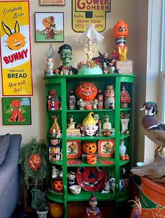 a green shelf filled with lots of halloween decorations