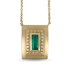 Displayed in a one of a kind, green-gold, Colombian emerald hand-made necklace. A divine 1.60-carat elongated emerald sits in a secure bezel setting. The alluring centerpiece displays a rich blue-green color, true to its prized origin; Muzo, Colombia. Beautiful clarity is seen in this gem as it is eye-clean, and small imperfections are natural, adding ambiance and character to the stone. A golden halo rises around the gemstone, providing texture and depth. A hand-brushed satin finish is dexterously applied to the unique green-gold piece. Setting Style: Bezel Setting Material: 18K Green & Yellow Gold Chain Length: 18 inches Main Stone: Colombian Emerald Shape: Elongated Emerald Cut Weight: 1.60-carat Total Stones: One Clarity: Very Good Color: Bluish Green Luster: Excellent Origin: Colombia Emerald Statement Necklace, Green Emerald Necklace, Necklace Emerald, 14k Yellow Gold Necklace, Solitaire Necklace, Solitaire Pendant Necklace, Gold Anniversary, Drop Pendant Necklace, Turtle Necklace