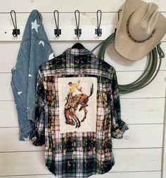 Hand bleached flannel shirt with the bucking horse on the back and Buck name patch sewed on the front, Due to hand bleaching colors may vary. We use a variety of flannel shirts so you may receive a different color than pictured but it will compliment the image. We use men's shirts so they are over sized. Mens Flannel Shirt Refashion, Flannel Upcycle, Flannel Shirt Refashion, Bleached Flannel Shirt, Shirt Makeover, Bleached Flannel, Cut Up Shirts, Bucking Horse, Upcycle Clothes Diy