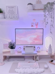 a desk with a computer, keyboard and mouse on it in front of some plants