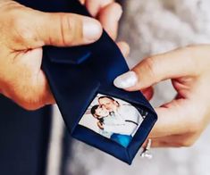 two hands holding an engagement ring with a photo in the middle, and another person's finger